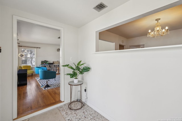 2334 W Huisache, San Antonio, TX 78201 - hallway featuring wood finished floors, baseboards, a chandelier, and visible vents