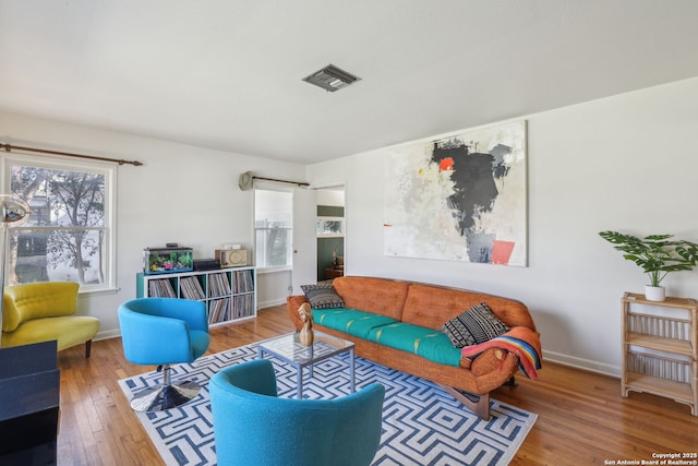 2334 W Huisache, San Antonio, TX 78201 - living area featuring baseboards, visible vents, and wood finished floors