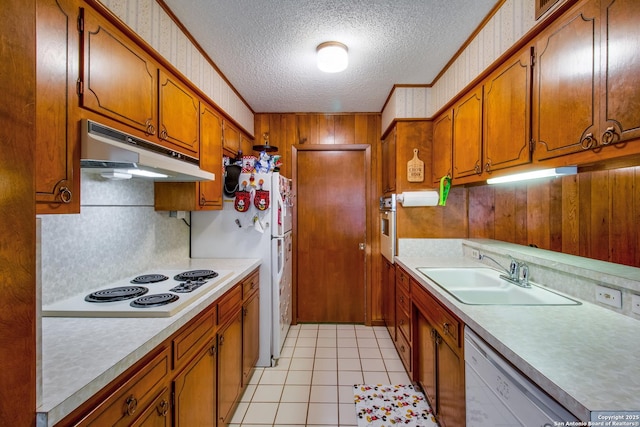 3422 William Penn Dr, San Antonio, TX 78230 - kitchen featuring a textured ceiling, white appliances, wallpapered walls, under cabinet range hood, and a sink
