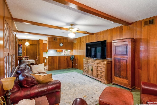 3422 William Penn Dr, San Antonio, TX 78230 - carpeted living area featuring wood walls, beamed ceiling, and a textured ceiling