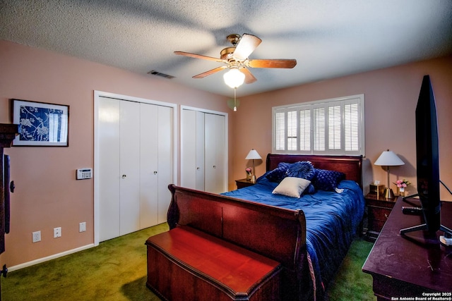 3422 William Penn Dr, San Antonio, TX 78230 - carpeted bedroom with visible vents, multiple closets, ceiling fan, and a textured ceiling