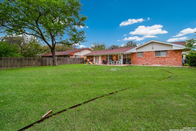 3422 William Penn Dr, San Antonio, TX 78230 - rear view of house with a patio, brick siding, a lawn, and fence private yard