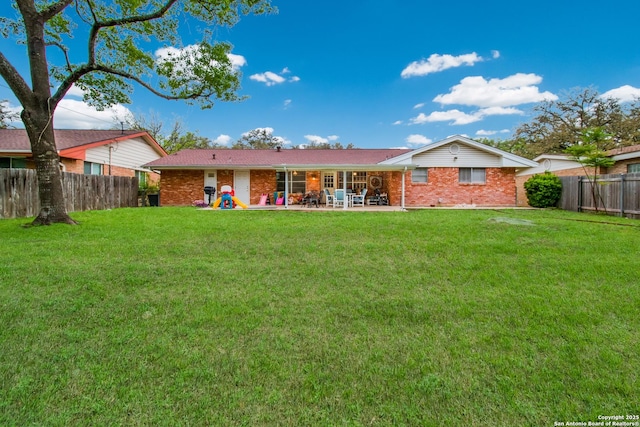 3422 William Penn Dr, San Antonio, TX 78230 - back of house featuring a fenced backyard, brick siding, and a yard