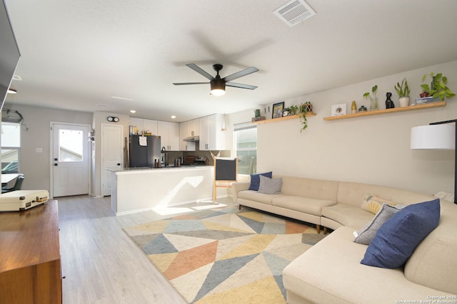 living area featuring ceiling fan, visible vents, recessed lighting, and light wood-type flooring