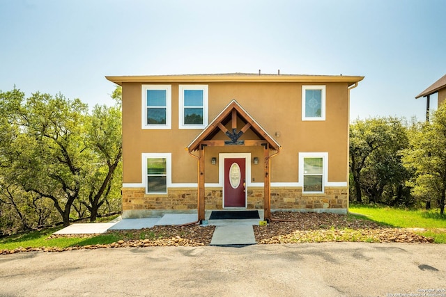 view of front facade with stone siding and stucco siding