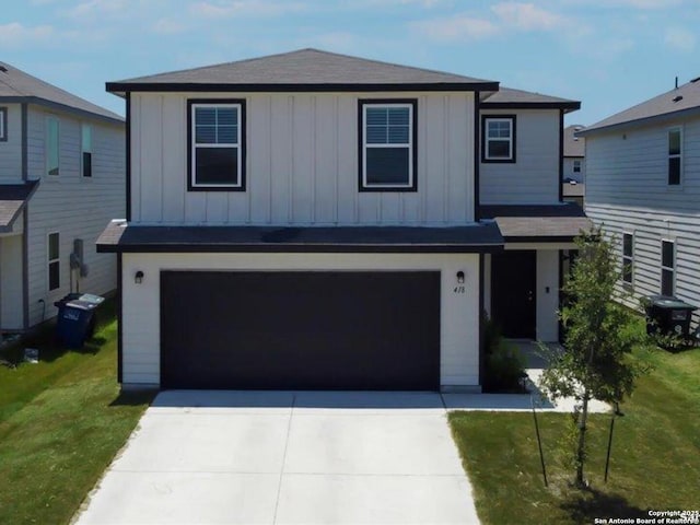 view of front facade featuring board and batten siding, an attached garage, a front lawn, and concrete driveway