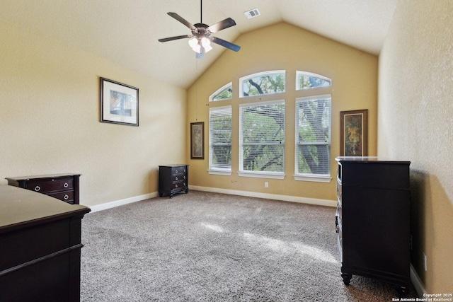interior space with carpet flooring, visible vents, ceiling fan, baseboards, and vaulted ceiling