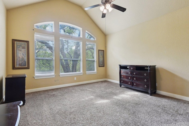 carpeted spare room featuring baseboards, a ceiling fan, and lofted ceiling