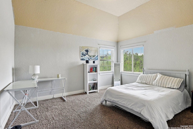 carpeted bedroom featuring baseboards, a textured wall, and vaulted ceiling