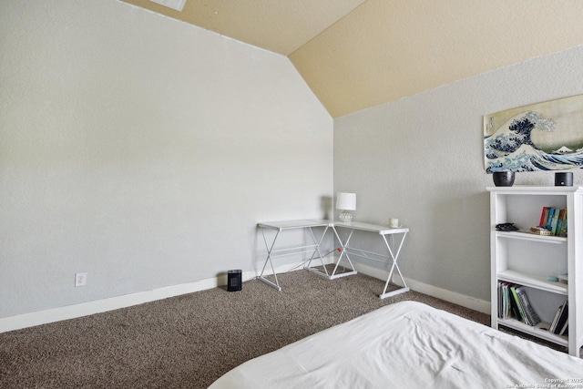 carpeted bedroom featuring lofted ceiling and baseboards