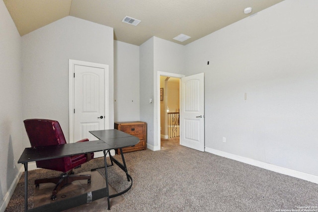 carpeted office space featuring visible vents, vaulted ceiling, and baseboards