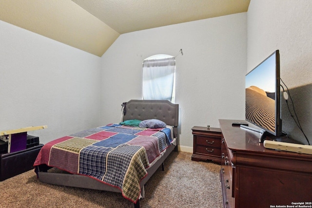 carpeted bedroom with vaulted ceiling