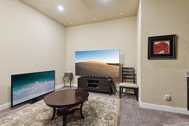 living area featuring carpet flooring and baseboards