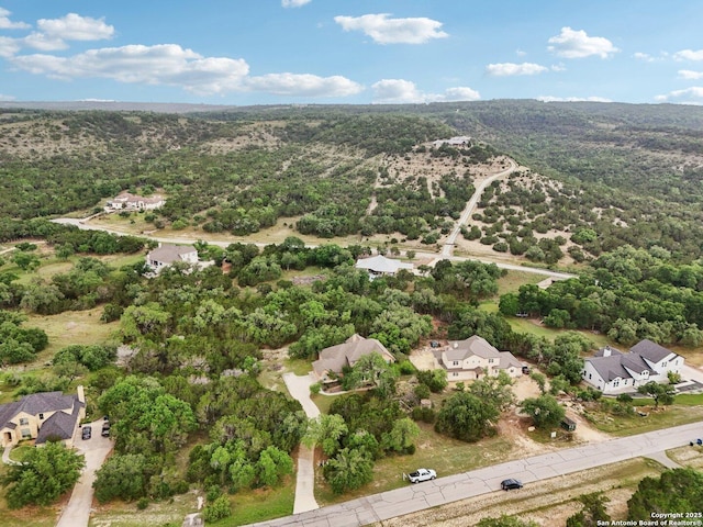 birds eye view of property with a forest view