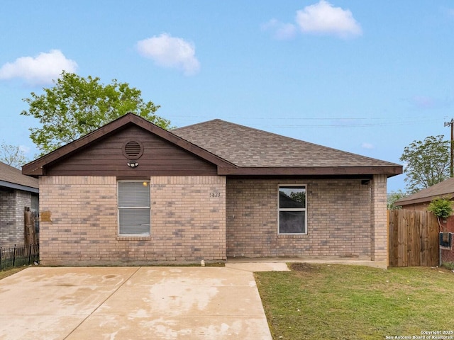 rear view of property with fence, a patio area, and brick siding