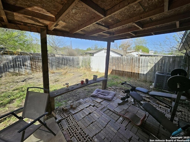 view of patio featuring central air condition unit and a fenced backyard
