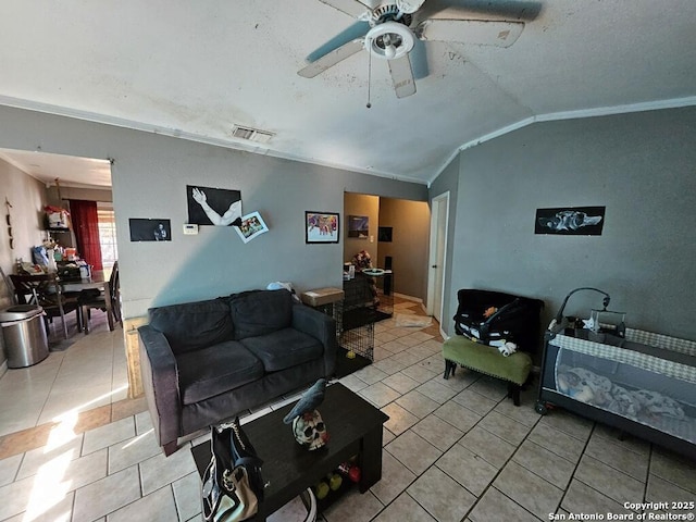 living room featuring visible vents, ceiling fan, ornamental molding, lofted ceiling, and light tile patterned floors