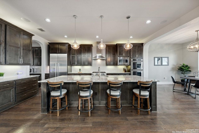 6743 Bella Colina, San Antonio, TX 78256 - kitchen with visible vents, dark brown cabinets, arched walkways, dark wood-style floors, and built in appliances