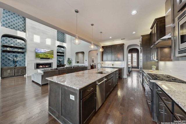 6743 Bella Colina, San Antonio, TX 78256 - kitchen with a sink, arched walkways, appliances with stainless steel finishes, and dark wood-style flooring