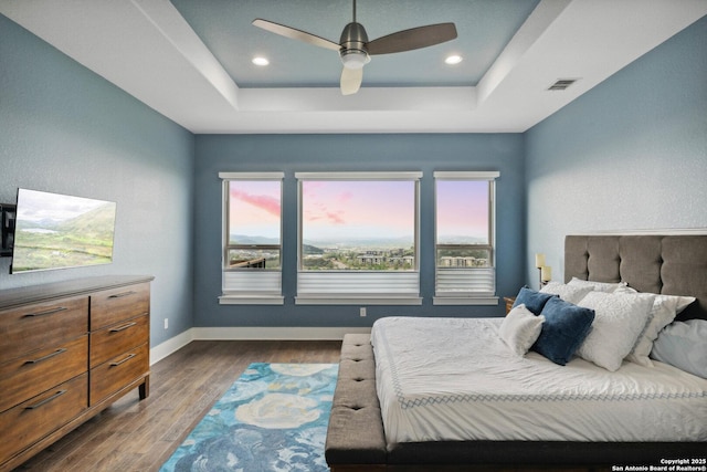 6743 Bella Colina, San Antonio, TX 78256 - bedroom with visible vents, baseboards, a ceiling fan, dark wood finished floors, and a tray ceiling