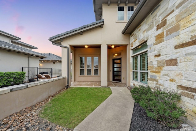 6743 Bella Colina, San Antonio, TX 78256 - view of exterior entry featuring a tile roof, stucco siding, fence, and stone siding