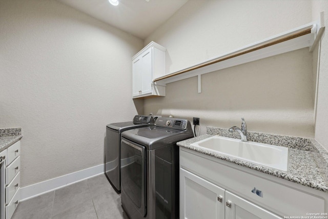 6743 Bella Colina, San Antonio, TX 78256 - laundry room featuring light tile patterned flooring, a sink, washing machine and clothes dryer, baseboards, and cabinet space
