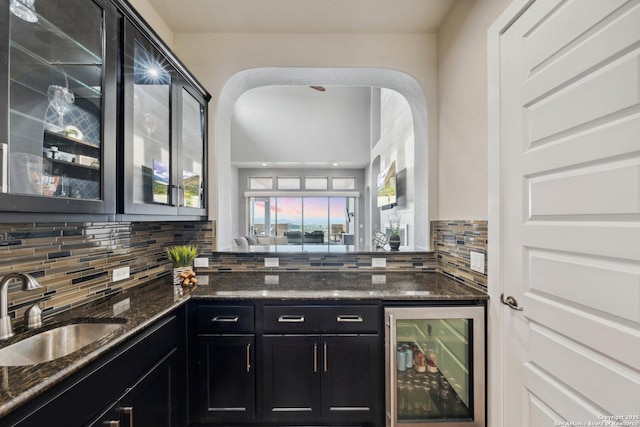6743 Bella Colina, San Antonio, TX 78256 - bar featuring wine cooler, a sink, indoor wet bar, arched walkways, and decorative backsplash
