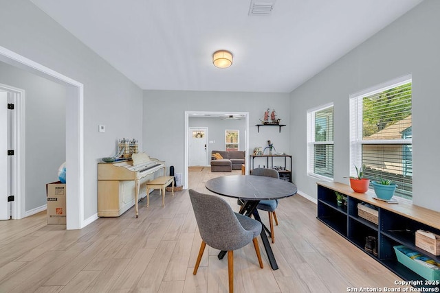 dining room featuring baseboards, light wood-style floors, and visible vents