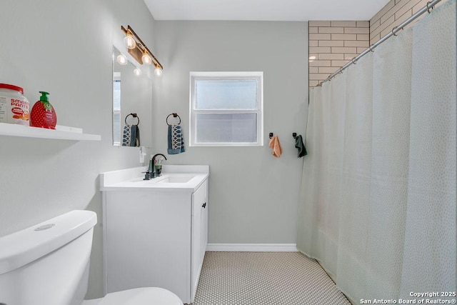 full bath featuring baseboards, toilet, and vanity