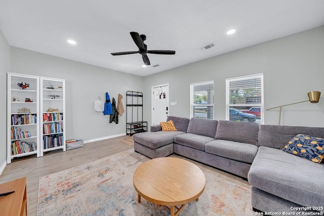 living area featuring recessed lighting, baseboards, ceiling fan, visible vents, and wood finished floors