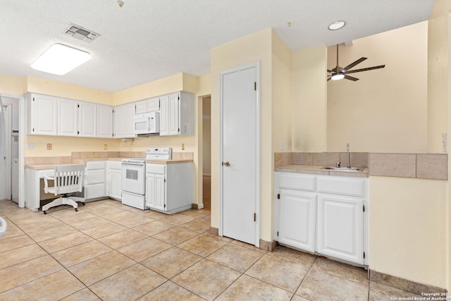 kitchen with light countertops, visible vents, white appliances, a ceiling fan, and white cabinetry