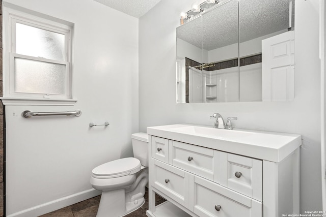 full bath with toilet, vanity, a textured ceiling, walk in shower, and baseboards