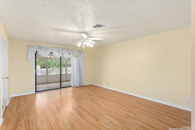 empty room featuring baseboards, ceiling fan, visible vents, and light wood-type flooring