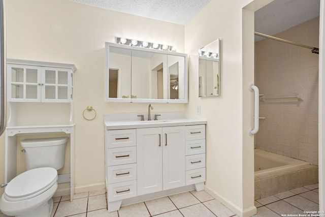 bathroom featuring a textured ceiling, baseboards, toilet, vanity, and tile patterned flooring
