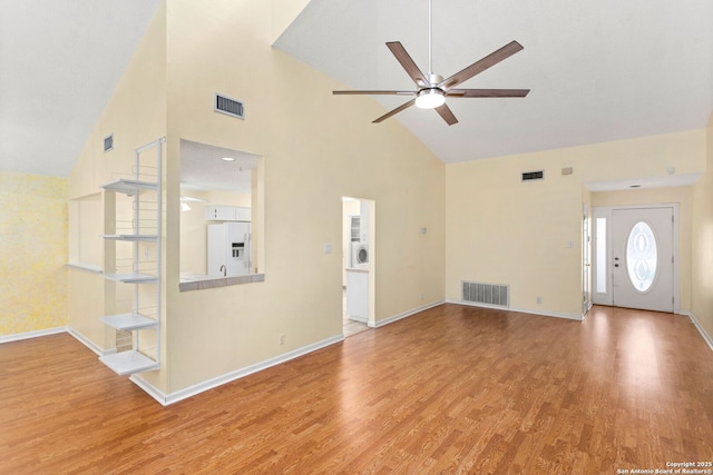 unfurnished living room featuring baseboards, visible vents, light wood-type flooring, and a ceiling fan