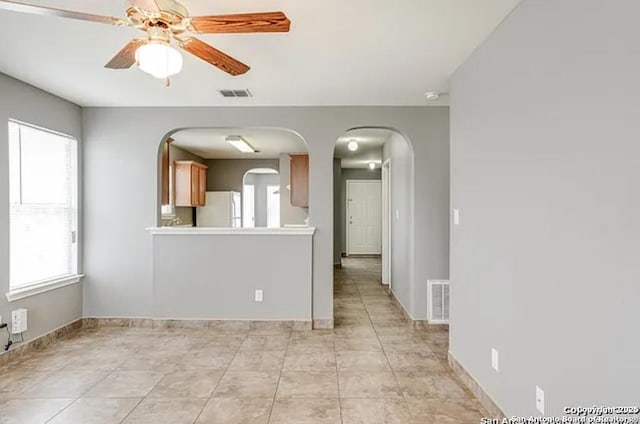 San Antonio, TX 78245 - spare room with baseboards, visible vents, arched walkways, and ceiling fan