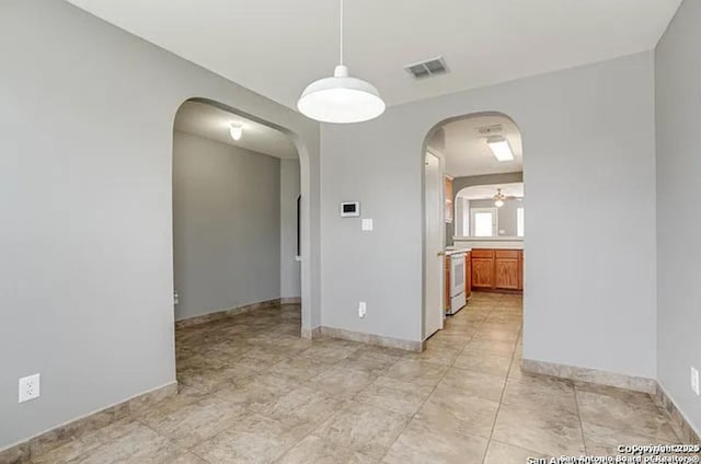 San Antonio, TX 78245 - empty room with arched walkways, baseboards, visible vents, and a ceiling fan