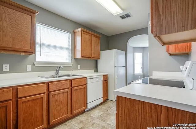 San Antonio, TX 78245 - kitchen featuring a sink, plenty of natural light, white appliances, visible vents, and arched walkways