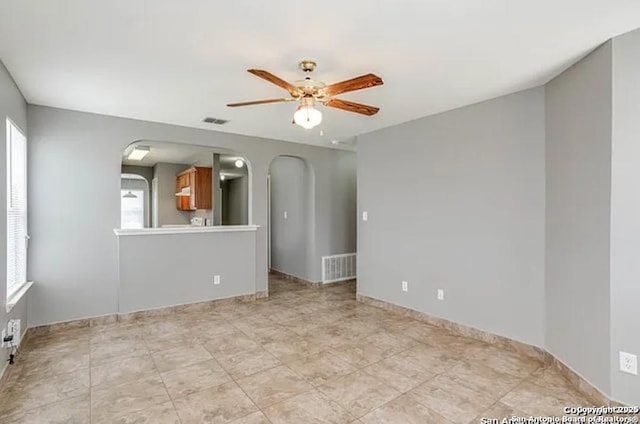 San Antonio, TX 78245 - unfurnished room with a ceiling fan, arched walkways, and visible vents