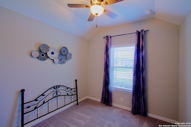 carpeted bedroom with baseboards, ceiling fan, and vaulted ceiling