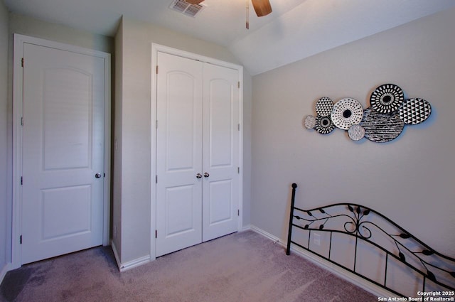 bedroom with carpet, a closet, lofted ceiling, and visible vents
