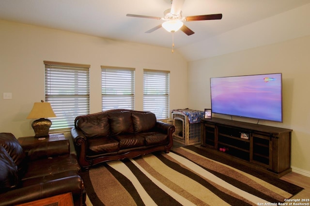 living room with baseboards, vaulted ceiling, and a ceiling fan