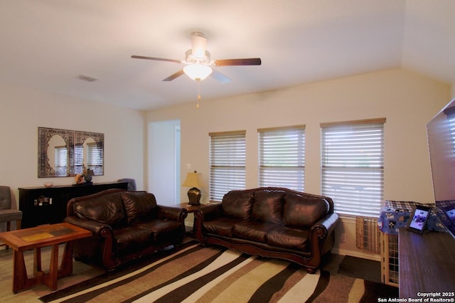 living room with vaulted ceiling, ceiling fan, and visible vents
