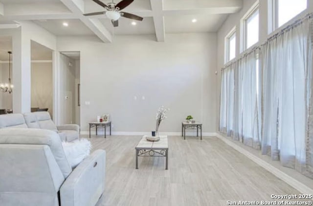 living room featuring coffered ceiling, wood finished floors, a ceiling fan, beam ceiling, and baseboards