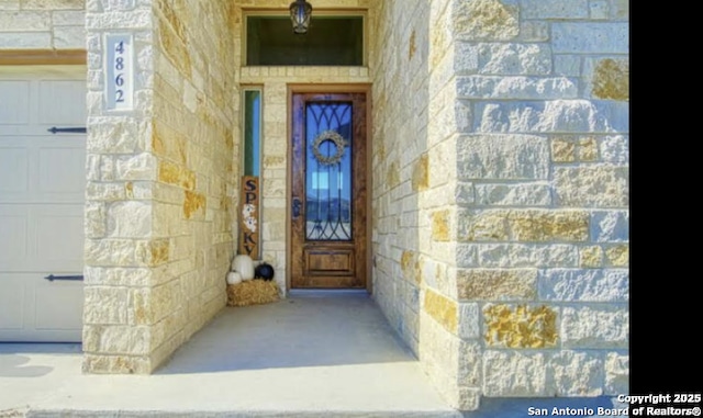 property entrance with stone siding