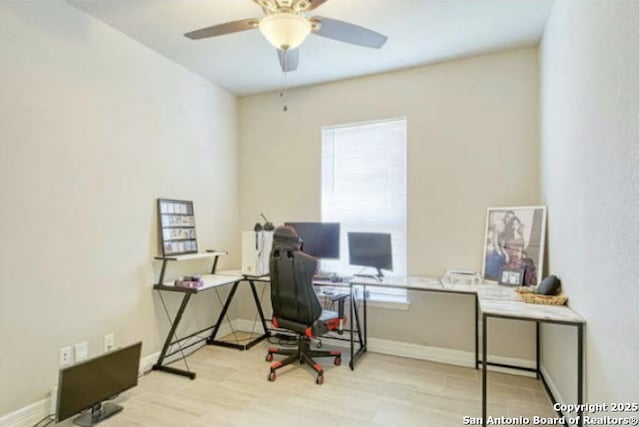 office space with baseboards, a ceiling fan, and wood finished floors