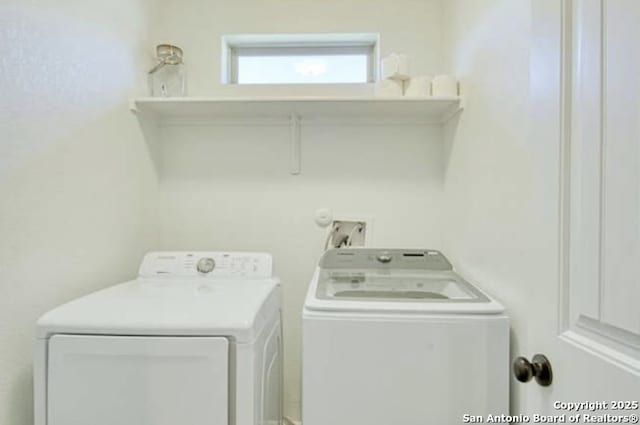 washroom with washing machine and clothes dryer and laundry area