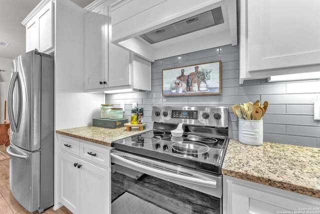 kitchen featuring custom range hood, white cabinets, appliances with stainless steel finishes, and light stone countertops