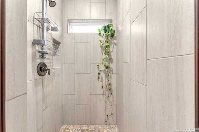 full bath featuring tiled shower