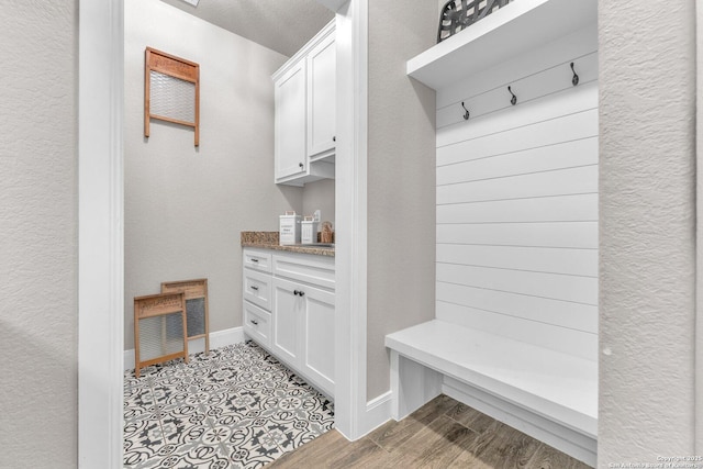 mudroom featuring visible vents, baseboards, and light wood finished floors